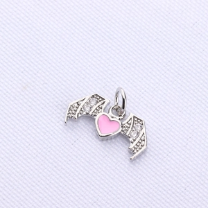 Detail of pink heart pendant with silver bat wings and sparkling zircon stone accents