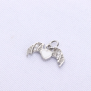 Detail of bat wing heart pendant with silver plating and zircon stones for DIY jewelry