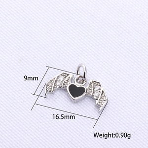 Macro detail of bat wing heart pendant with black enamel and zircon stones, 16.5mm size