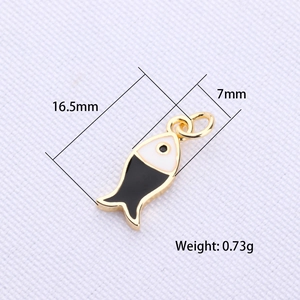 Detail showing gold fish pendant dimensions 16.5mm by 7mm with black and white enamel