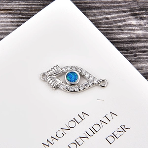 Macro view of evil eye connector with blue opal and white zircons for DIY jewelry