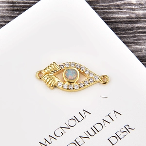 Detail of opal evil eye connector with gold plating and cubic zirconia for DIY jewelry