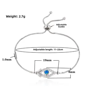 Detail of adjustable slider clasp and opal evil eye connector on a box chain bracelet