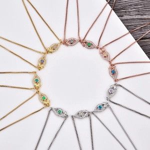 Macro detail of opal evil eye connectors in gold, silver and rose gold finishes