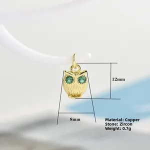 Detailed view of copper owl pendant with green cubic zirconia eyes 12mm x 8mm