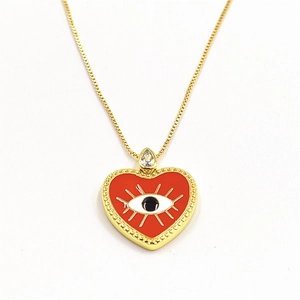Detail of red heart evil eye pendant with micro-inset zircon and gold-plated copper chain