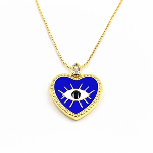 Macro detail of gold evil eye heart pendant with blue enamel and cubic zirconia