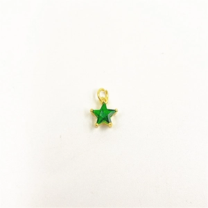 Detailed close-up of a star-shaped green zircon pendant with a golden metal base