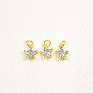 Macro view of three gold pentagram pendants with cubic zirconia for DIY jewelry making