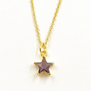 Detail of a purple star-shaped pendant on a fine golden chain necklace for women