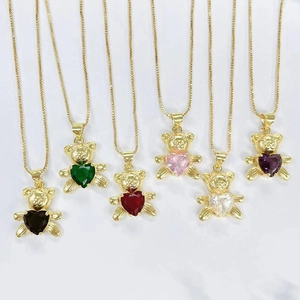 Detail of copper bear pendants with various heart-shaped gemstones on gold-plated necklaces