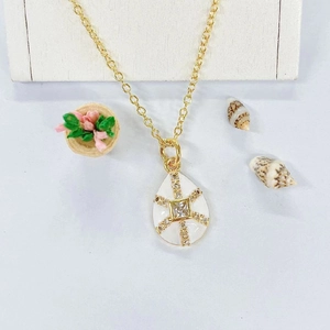 Gold water drop pendant necklace with white enamel star and cubic zirconia inlay