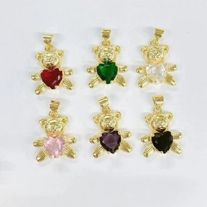 Detail of six panda bear pendants in gold plated copper with multi-colored heart stones