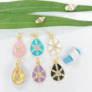 Detailed view of colorful drop pendants with cubic zirconia and gold enamel finish