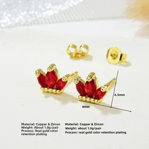 Macro shot of 8x6.5mm copper crown studs with red zircon and real gold plating