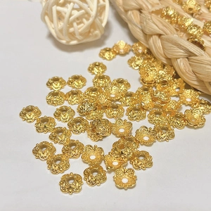 Macro view of 18k gold plated filigree flower bead caps for DIY jewelry crafting