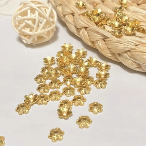 Detailed macro view of 18k gold plated hollow flower petal bead caps for DIY jewelry making