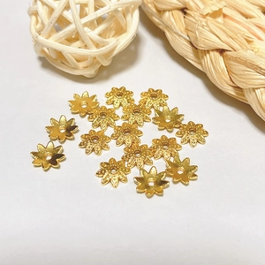 Detailed close-up of 18k gold-plated hollow petal flower bead caps for DIY jewelry making