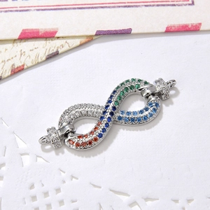 Macro detail of infinity jewelry connector with colorful micro-pave cubic zirconia crystals