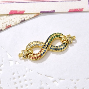 Macro detail of infinity symbol jewelry connector with colorful micro-pave zircons