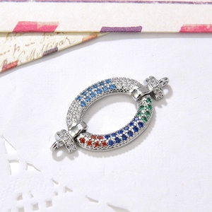 Macro view of oval connector with pavé zircon stones and dual hooks for DIY jewelry