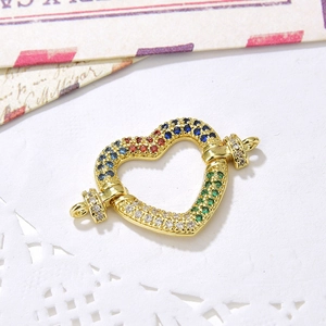 Macro shot of heart-shaped multi-color zircon connector clasp for jewelry DIY crafts