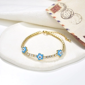Bracciale tennis dorato con fiori dell'occhio del male blu e pietre di zirconi cubici