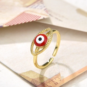 Macro shot of gold Evil Eye ring with red enamel inlay and adjustable band detail