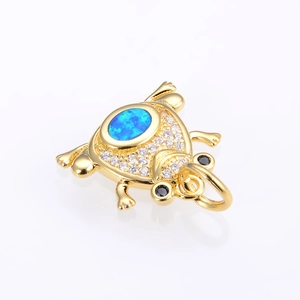 Detailed view of frog pendant with blue opal and white cubic zirconia stones