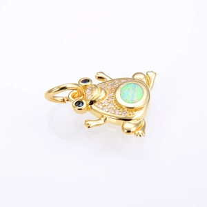 Detail of frog pendant with opal back, clear zircon stones, and blue eyes on gold plating