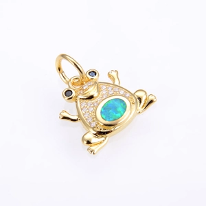 Detail of copper frog pendant with white zircon pavé and blue opal stone inlay