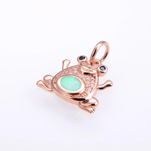 Macro shot of rose gold frog pendant with green opal and shimmering zircon pavé