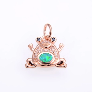 Detail of rose gold frog pendant featuring green opal stone and micro-pave crystals