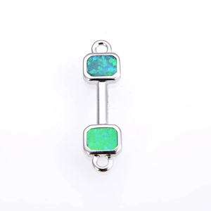 Macro shot of a dumbbell shaped connector with green synthetic opal in silver finish