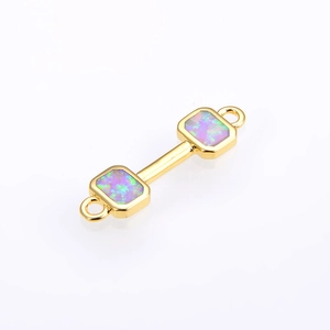 Macro detail of dumbbell connector with opal stones and 18K gold plated finish