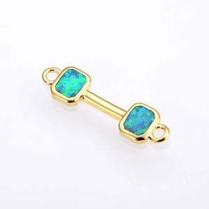 Macro view of gold-plated dumbbell connector with blue-green opal inlay for DIY jewelry
