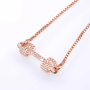 Rose gold dumbbell pendant necklace with shimmering zircon accents on box chain