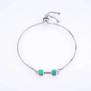 Macro shot of adjustable silver box chain with green opal dumbbell pendant