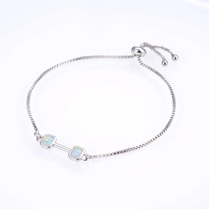 Macro detail of adjustable box chain bracelet featuring square opal stones in silver setting