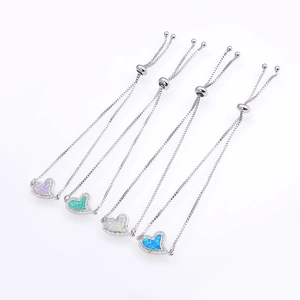 Detail view of heart-shaped opal bracelets with adjustable silver slide chains and zircons