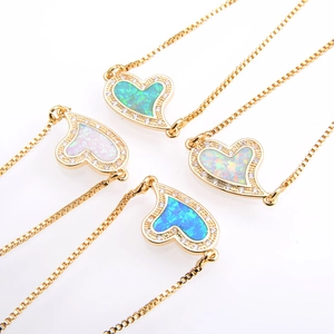 Set of four gold heart bracelets featuring opal inlays and sparkling zircon accents