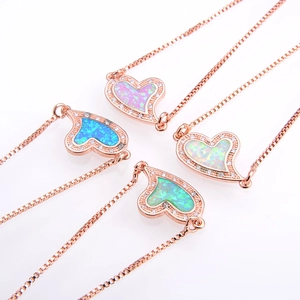 Detailed view of four heart opal bracelets in pink, blue, white, and green with rose gold finish