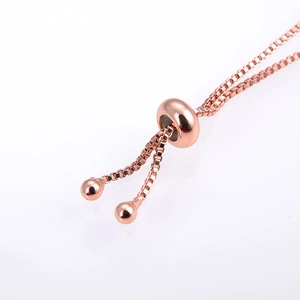 Adjustable rose gold box chain bracelet featuring a sleek slider bead and dolphin opal charm