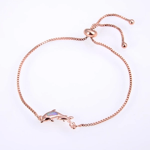 Detailed macro view of a rose gold dolphin bracelet with adjustable box chain closure