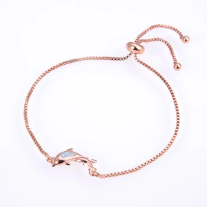 Detail of rose gold dolphin bracelet with opal inlay and adjustable sliding clasp
