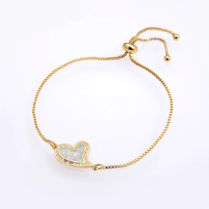 Detail of adjustable gold box chain with opal heart charm and sparkling zircon accents