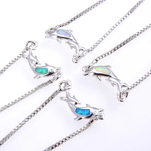 Macro detail of dolphin opal pendants on box chains in four vibrant synthetic colors