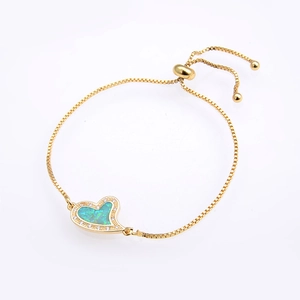 Detail of adjustable gold heart bracelet with teal opal inlay and zircon stones