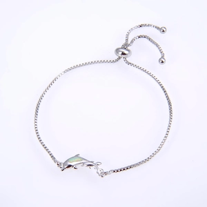 Detail of silver box chain bracelet with opal dolphin charms and adjustable slider buckle