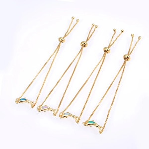 Detailed view of four adjustable gold-tone dolphin bracelets with colorful opal inlays